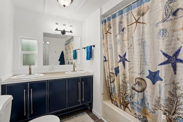 full bathroom featuring shower / tub combo with curtain, wood-type flooring, toilet, and vanity