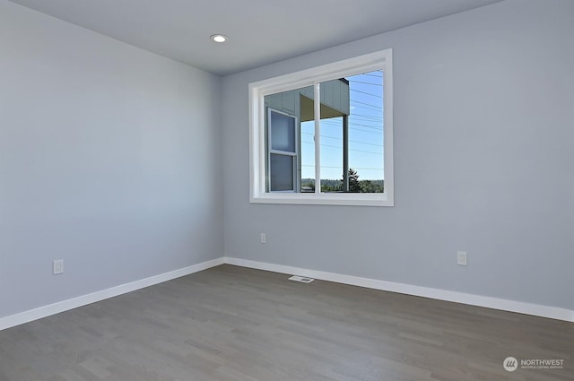 spare room featuring dark hardwood / wood-style flooring