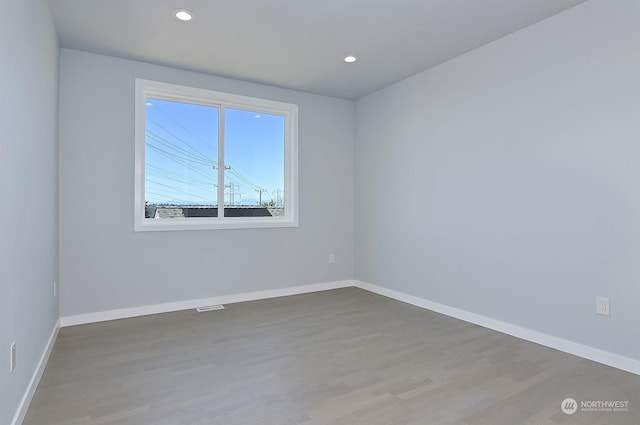 empty room with wood-type flooring