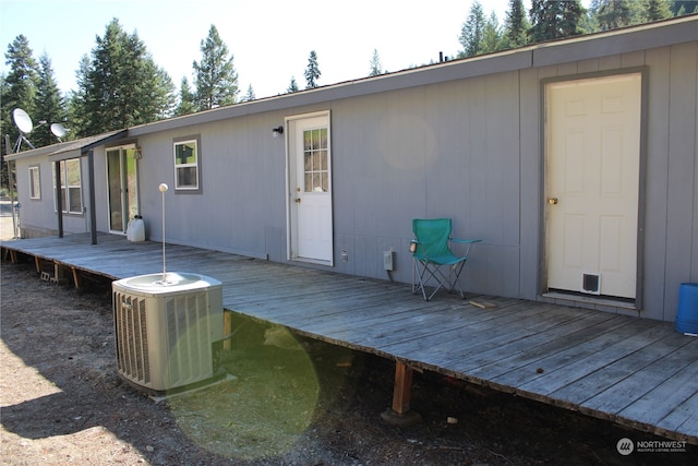 back of house featuring a wooden deck and central air condition unit