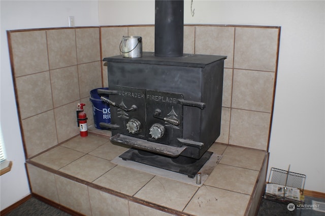 interior details with a wood stove and tile patterned floors