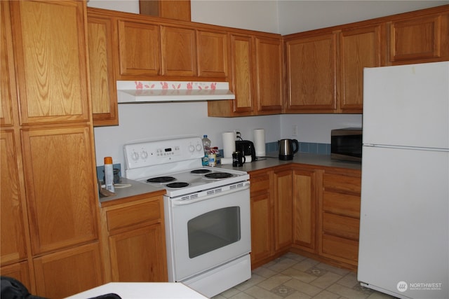 kitchen with light tile patterned floors and white appliances