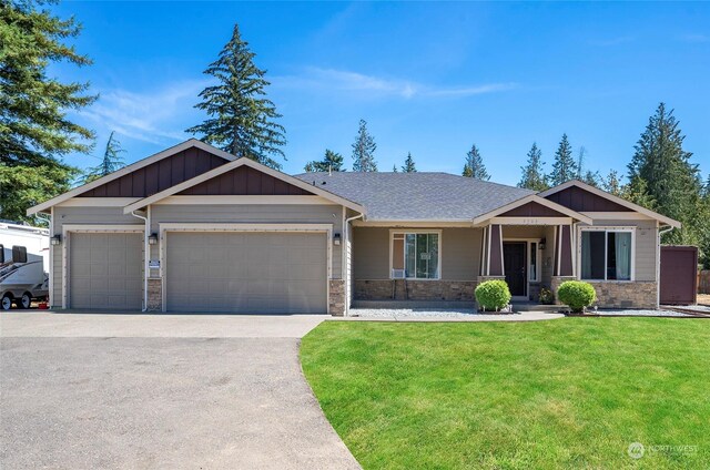 view of front of property featuring a garage and a front lawn