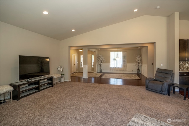 living room featuring carpet floors and high vaulted ceiling