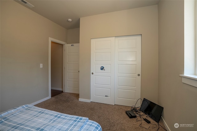 unfurnished bedroom featuring a closet and carpet floors