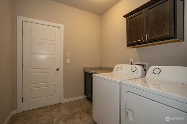 clothes washing area featuring separate washer and dryer, cabinets, and light tile patterned floors