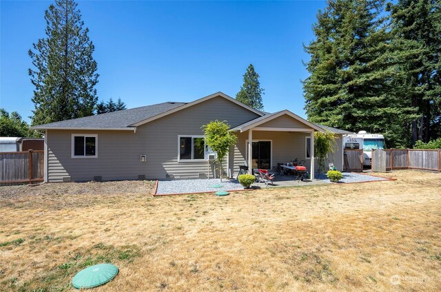 back of house featuring a yard and a patio area