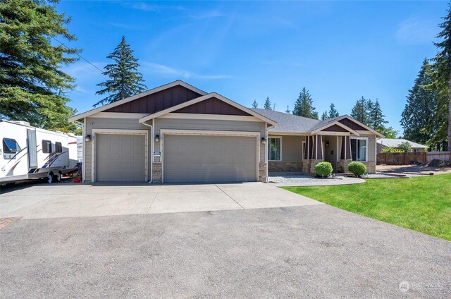 view of front facade with a garage and a front lawn