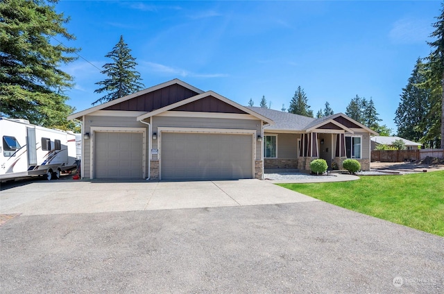 view of front of house with a garage and a front lawn