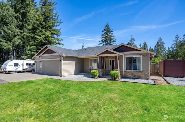 view of front of home featuring a garage and a front lawn