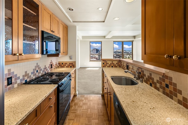 kitchen featuring light parquet floors, black appliances, tasteful backsplash, sink, and light stone countertops