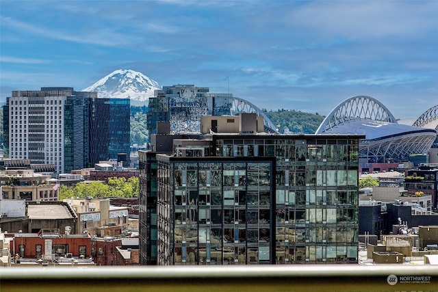 property's view of city featuring a mountain view