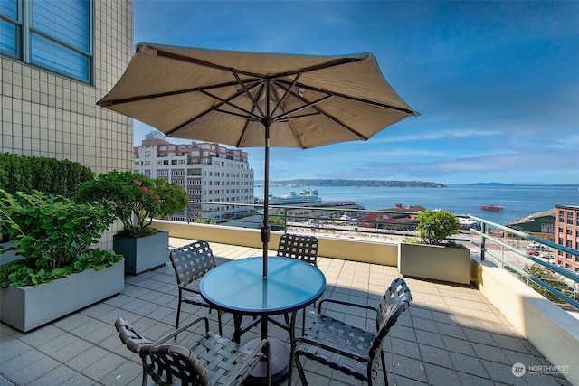 view of patio / terrace featuring a balcony and a water view