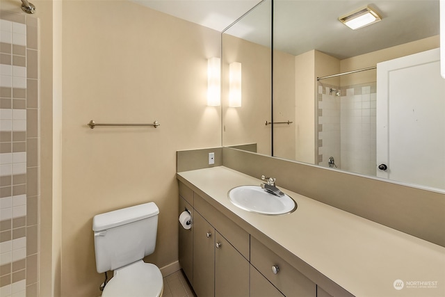 bathroom featuring tile patterned floors, toilet, and vanity