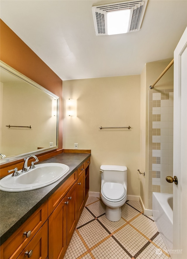 full bathroom with shower / tub combination, vanity, tile patterned flooring, and toilet