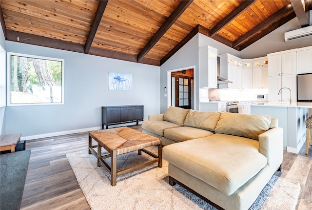 living room with lofted ceiling with beams, sink, wooden ceiling, a wall unit AC, and light hardwood / wood-style flooring