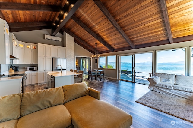 unfurnished living room featuring dark wood-type flooring, high vaulted ceiling, a wall mounted AC, a water view, and wooden ceiling