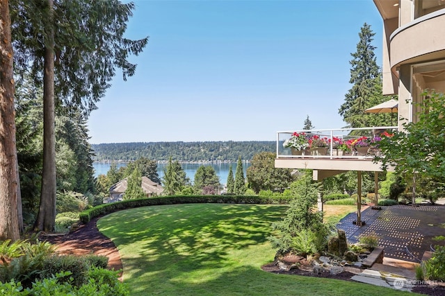 view of yard featuring a water view and a balcony