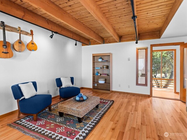 sitting room featuring rail lighting, light hardwood / wood-style floors, and wooden ceiling