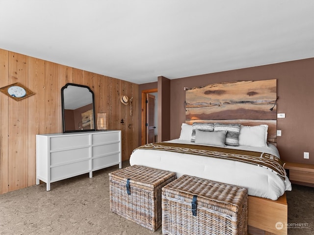 bedroom featuring wood walls