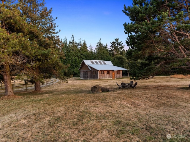 exterior space with a front lawn and an outdoor structure