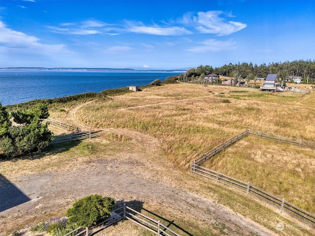 birds eye view of property featuring a water view and a rural view