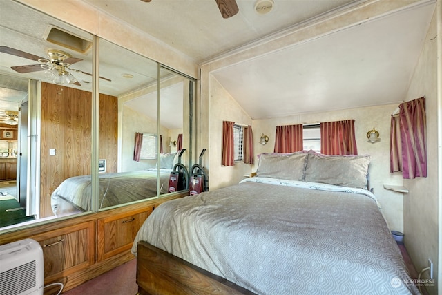 bedroom featuring lofted ceiling, carpet flooring, a closet, and ceiling fan