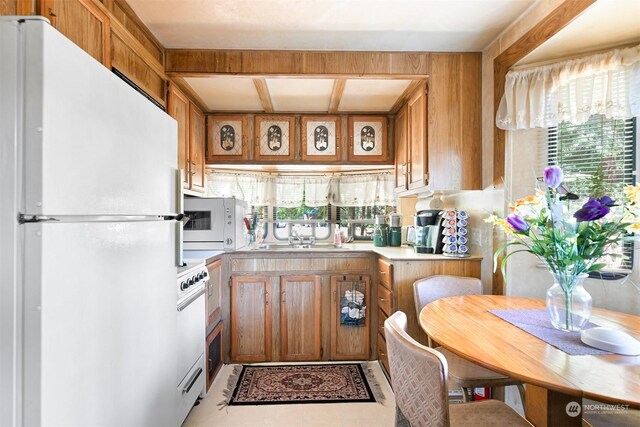 kitchen featuring sink and white appliances