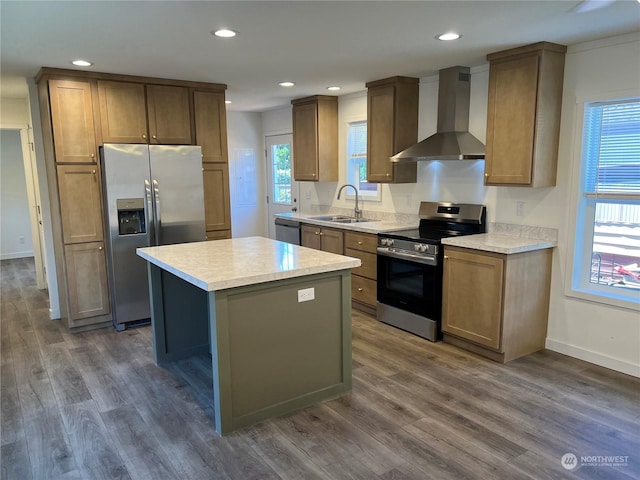 kitchen with a kitchen island, dark hardwood / wood-style floors, sink, stainless steel appliances, and wall chimney range hood