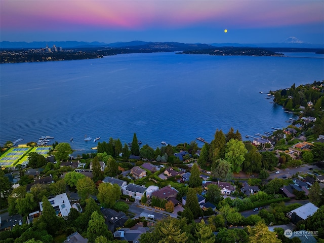 aerial view at dusk with a water view