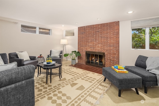 living room featuring a brick fireplace