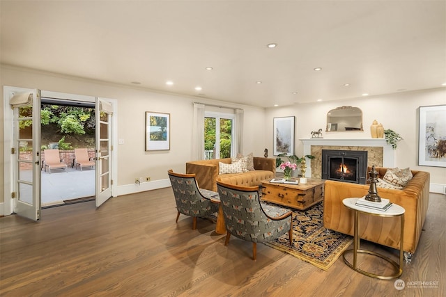 living room with crown molding, hardwood / wood-style floors, and french doors