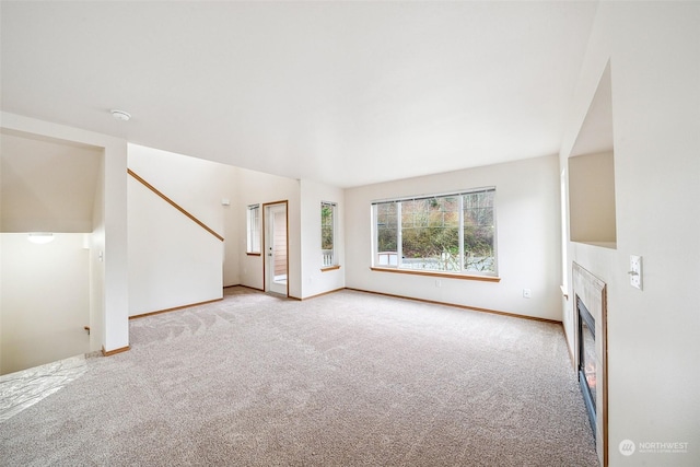 unfurnished living room featuring light colored carpet