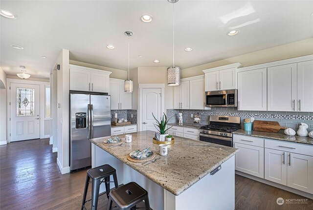 kitchen featuring backsplash, dark hardwood / wood-style floors, and stainless steel appliances