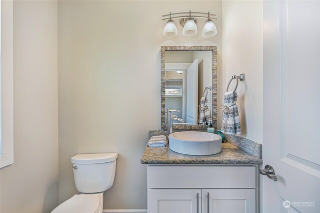 bathroom featuring toilet and vanity