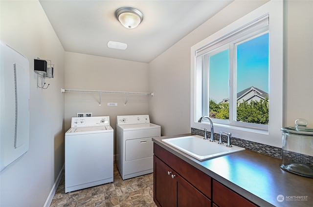 laundry area featuring sink, washer and clothes dryer, and light tile patterned floors