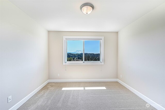 empty room featuring light colored carpet