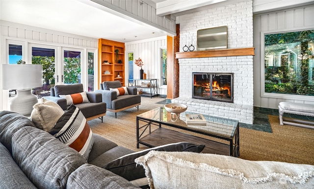 living room with carpet, wooden walls, and a fireplace