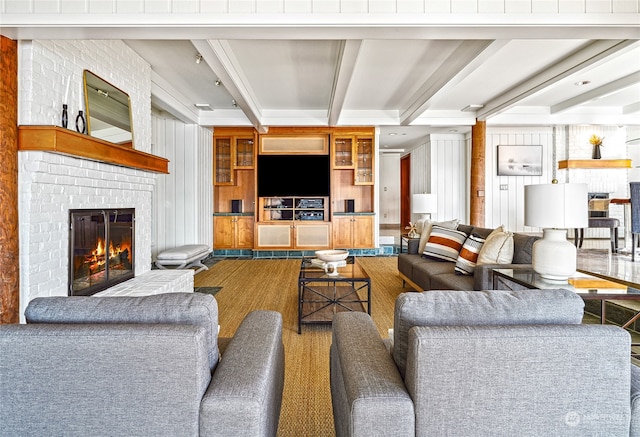 living room with hardwood / wood-style floors, beam ceiling, wood walls, and a brick fireplace