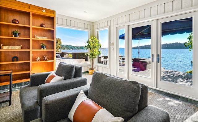 interior space with french doors, a water view, and tile patterned flooring