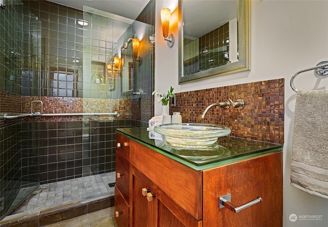 bathroom with vanity, walk in shower, decorative backsplash, and tile patterned flooring