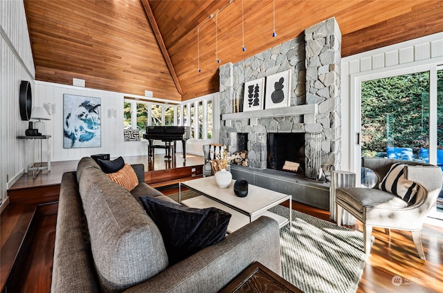 living room with high vaulted ceiling, wood walls, wood-type flooring, a stone fireplace, and wooden ceiling