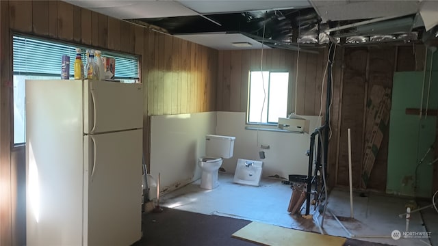 basement featuring white fridge