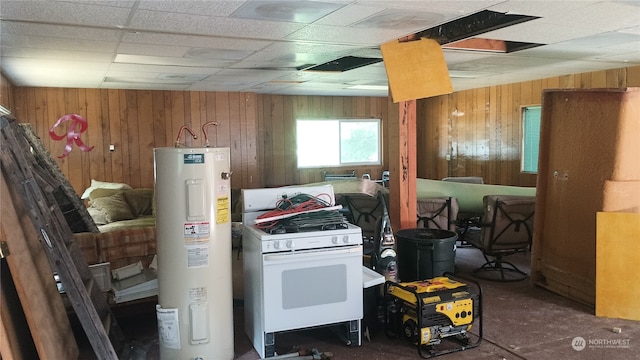 kitchen with wooden walls, electric water heater, white range with gas stovetop, and a paneled ceiling