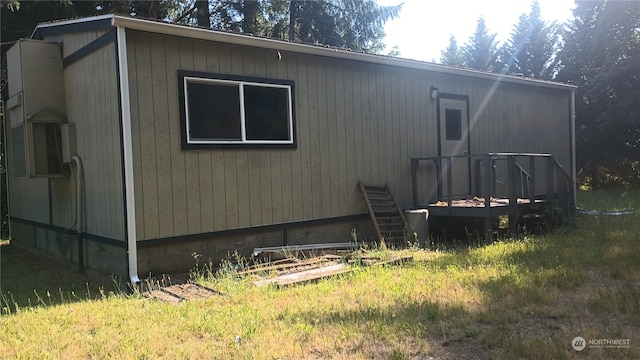 view of home's exterior with a wooden deck