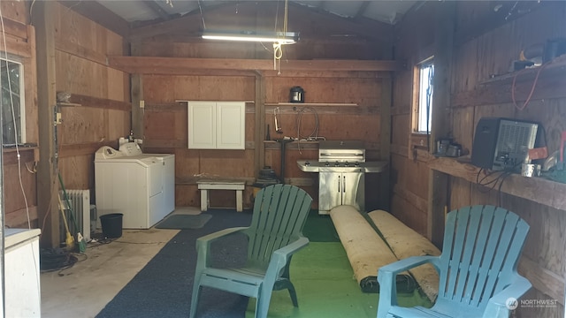 garage with separate washer and dryer and wooden walls