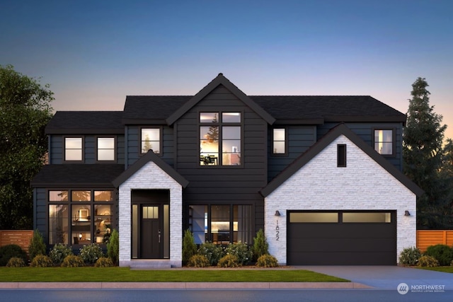 view of front facade with a garage and a yard