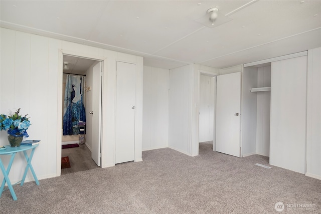 unfurnished bedroom with carpet floors and ensuite bath