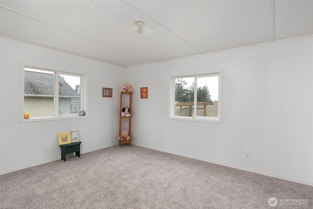 carpeted empty room featuring baseboards