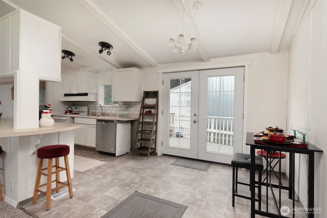 kitchen featuring backsplash, light countertops, french doors, stainless steel dishwasher, and beam ceiling